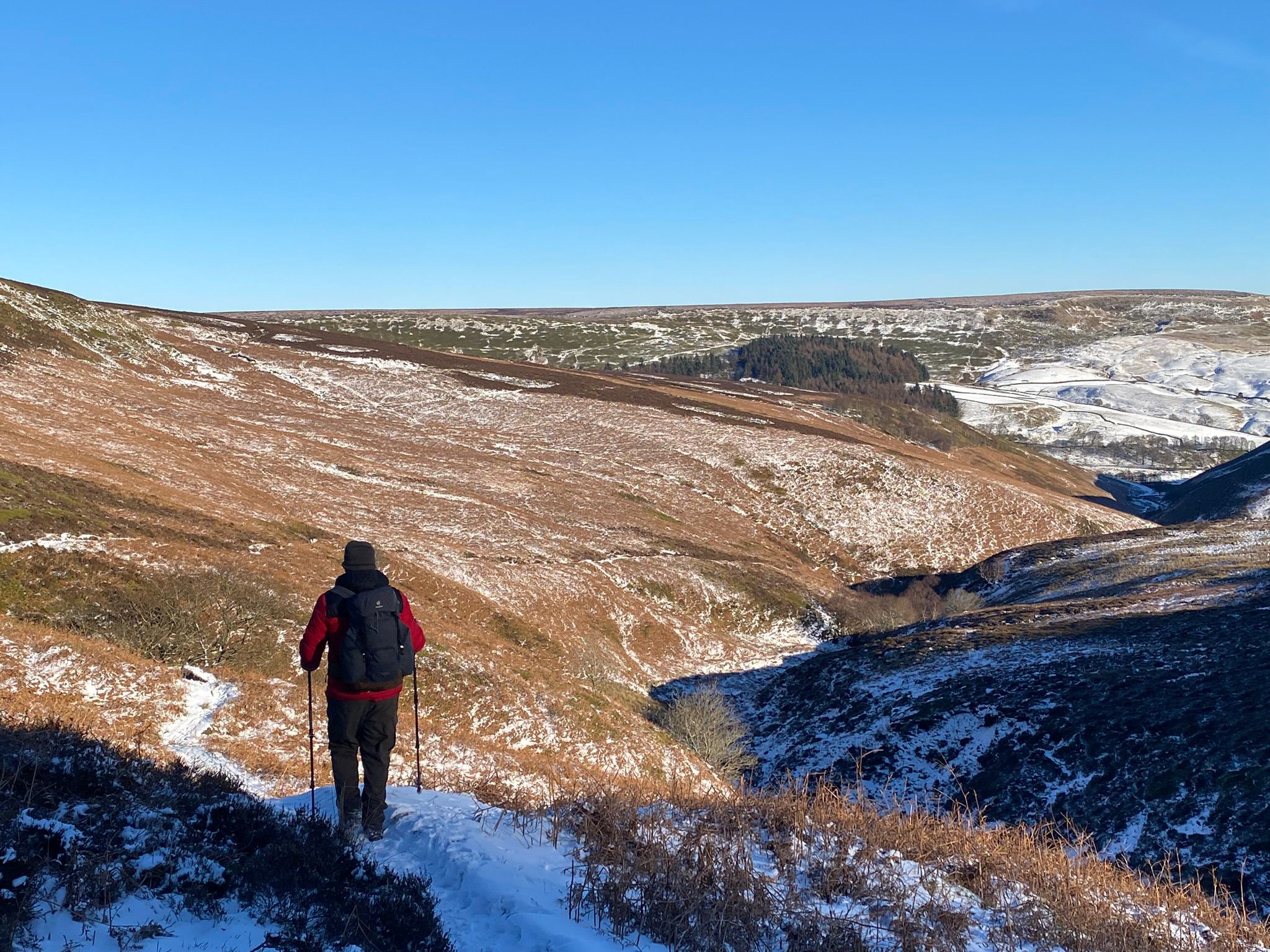 Paul Martin walking through a winter Peak District landscape during a Walk and Talk route
